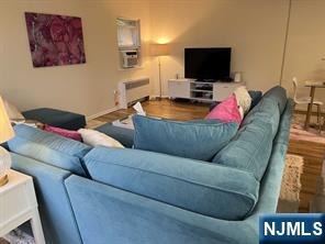 280-320 Oak Street, Unit 304D Ridgewood, NJ 07450 - Photo 7 of 23 a living room with furniture and a flat screen tv