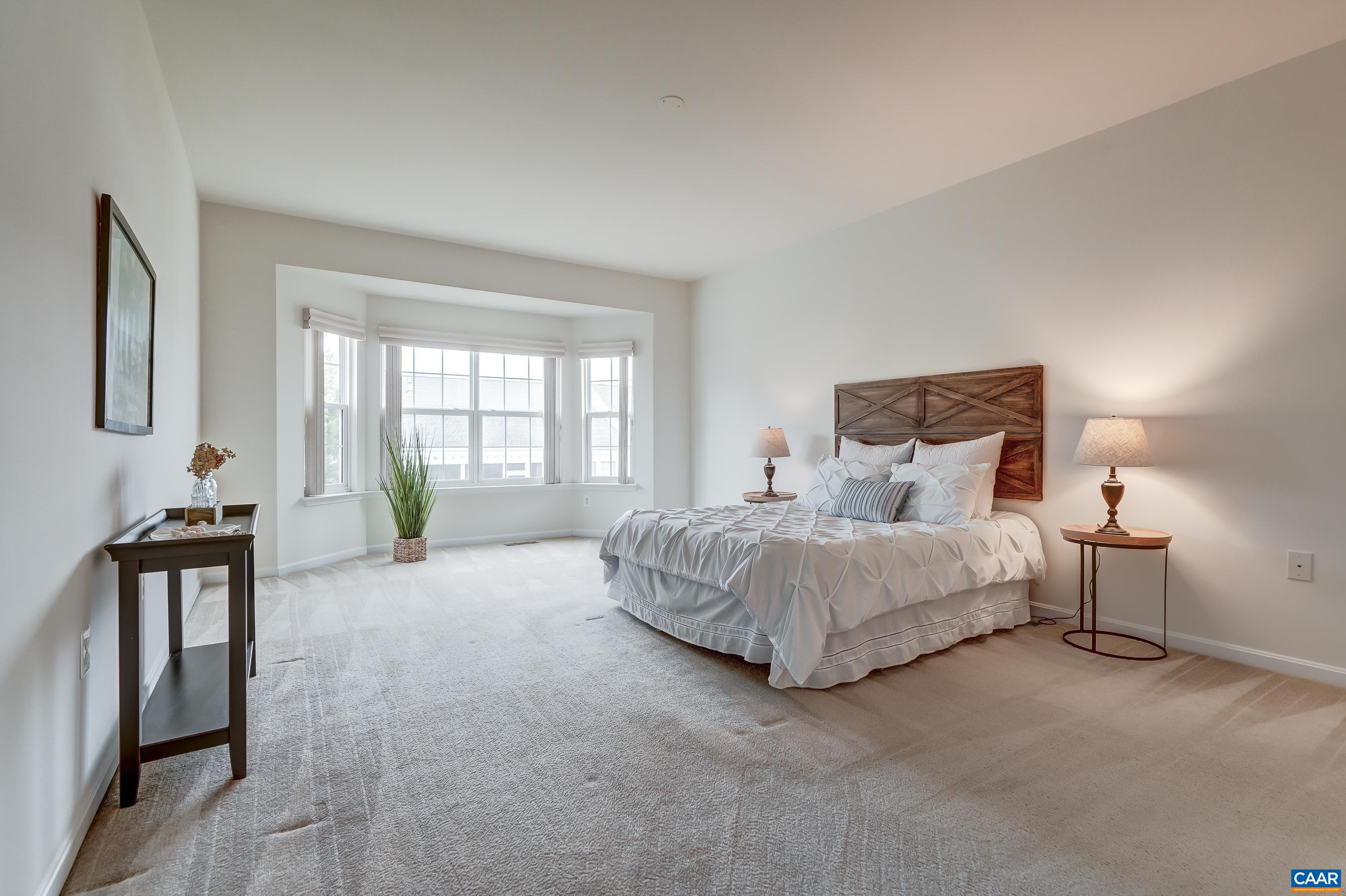 65 Prestwood Drive Ruckersville, VA 22968 - Photo 28 of 61 a spacious bedroom with a bed and a large window