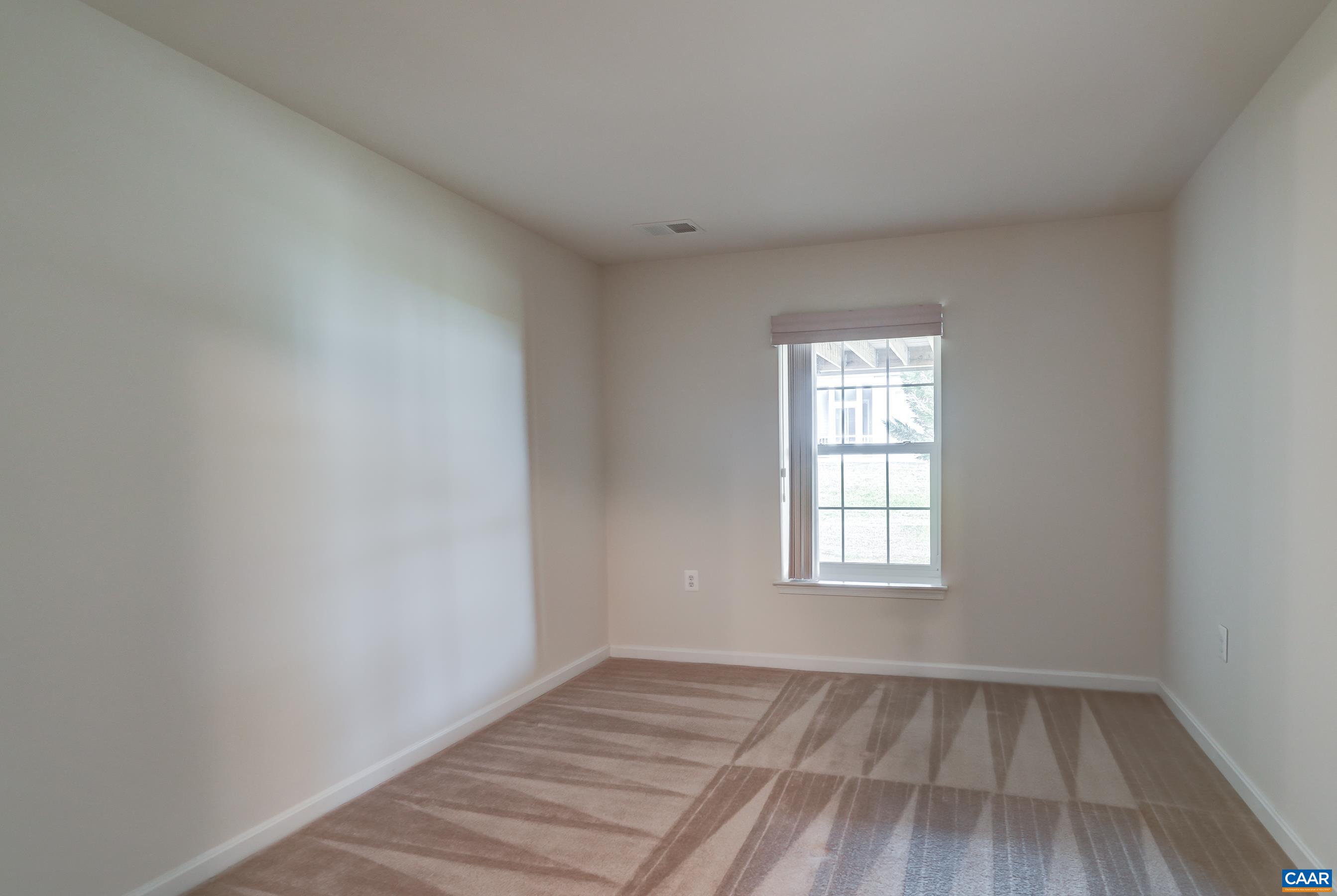 65 Prestwood Drive Ruckersville, VA 22968 - Photo 47 of 61 an empty room with wooden floor and windows