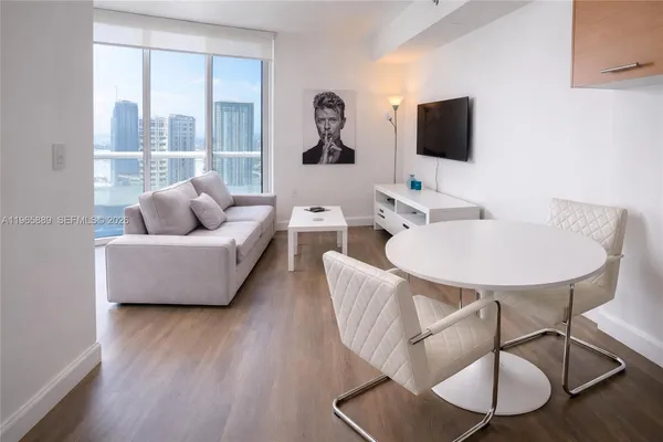 a living room with furniture and a flat screen tv