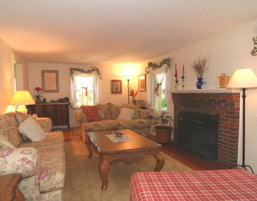 15 Lovell Road Arlington, MA 02474 - Photo 3 of 18 a living room with furniture and a fireplace