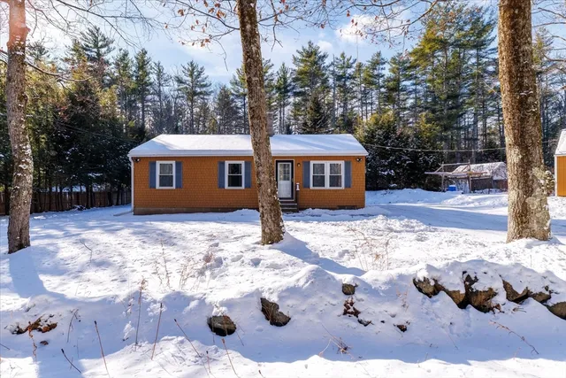a view of house with yard covered in snow