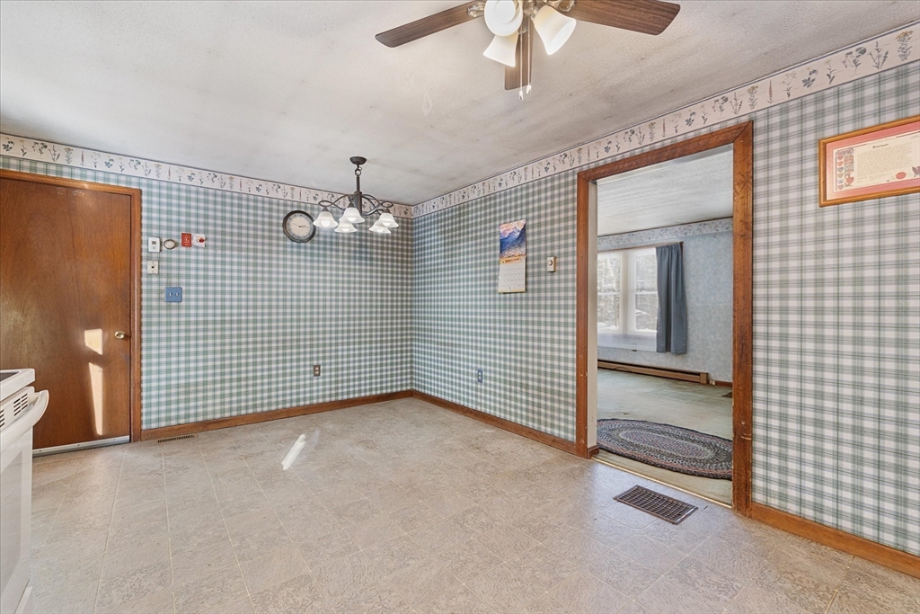 690 Clark Street Gardner, MA 01440 - Photo 7 of 26 en empty room with windows and ceiling fan