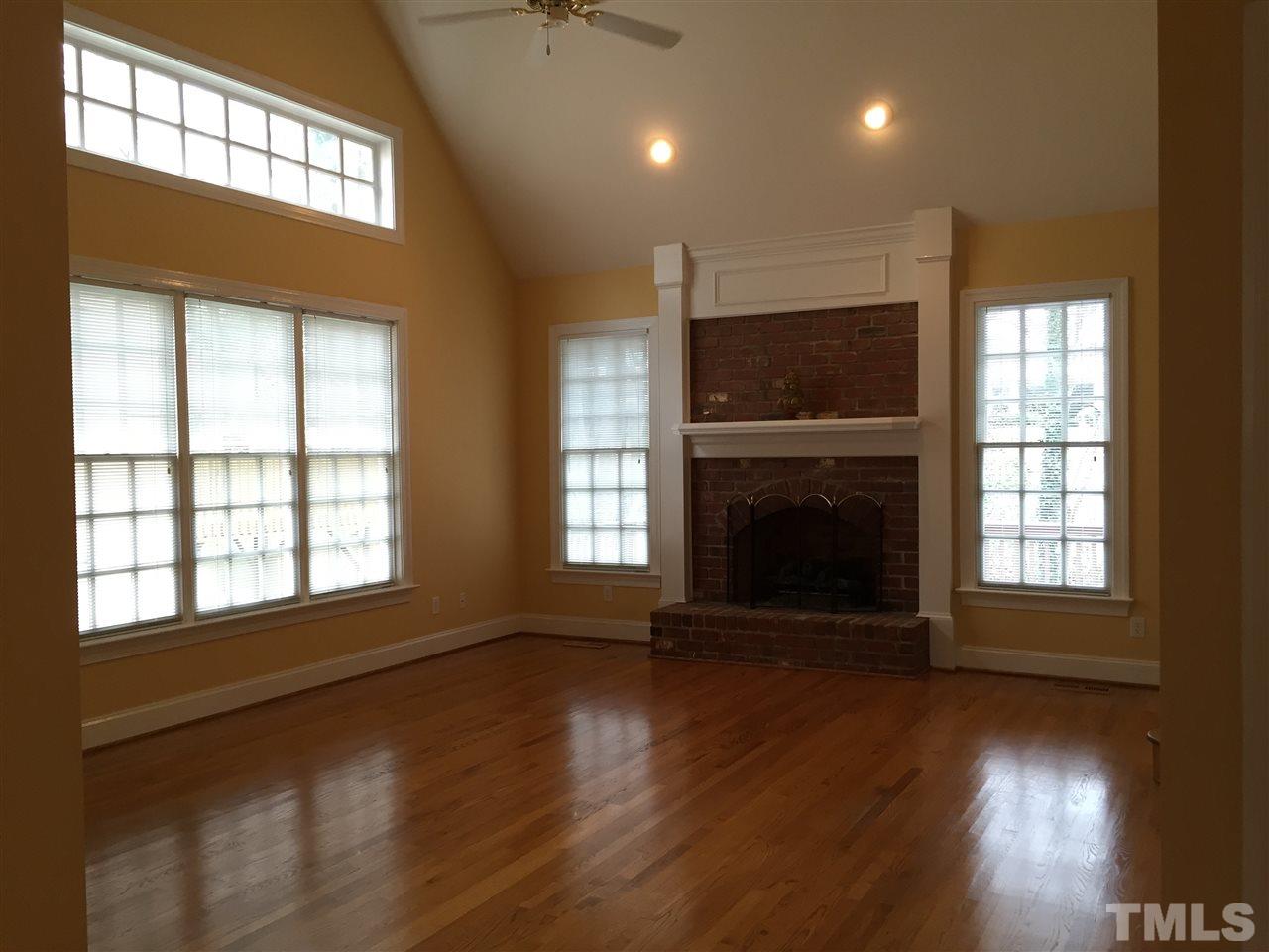 127 Yorkchester Way Raleigh, NC 27615 - Photo 5 of 25 a view of an empty room with wooden floor and a window