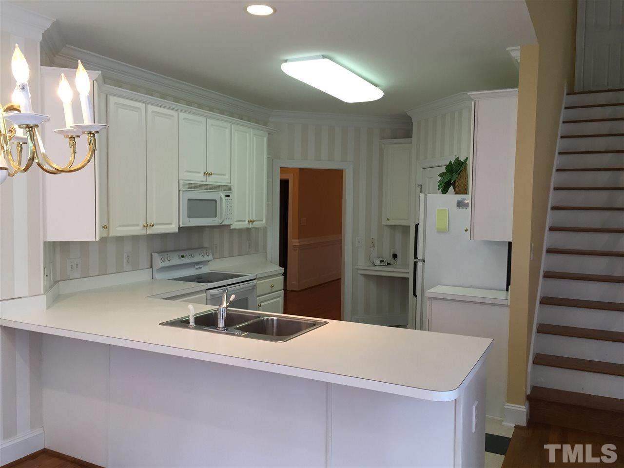 127 Yorkchester Way Raleigh, NC 27615 - Photo 10 of 25 a kitchen with a sink and a refrigerator