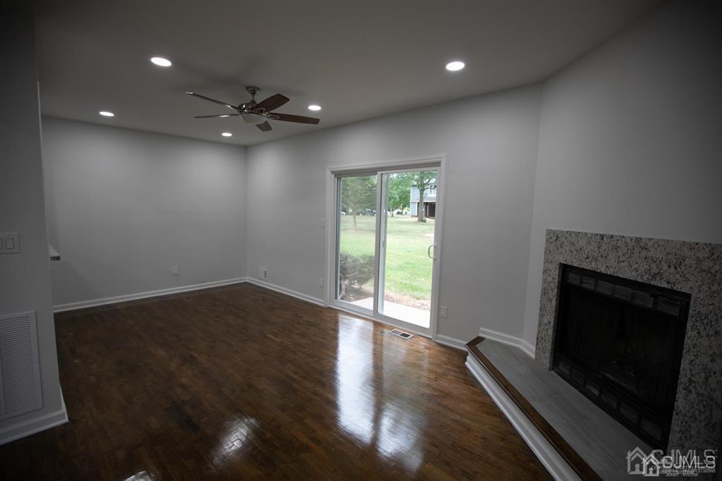 4208 Hana Road Edison, NJ 08817 - Photo 14 of 34 an empty room with wooden floor and fireplace