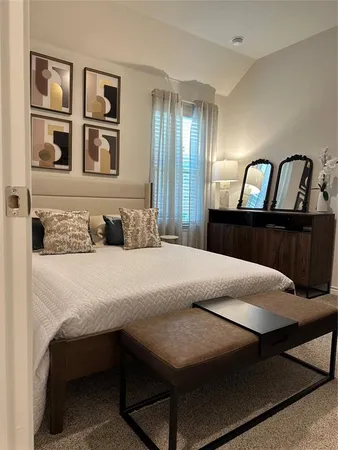 a bedroom with a bed and dresser