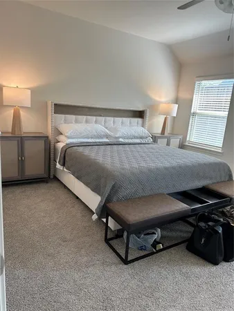 a bedroom with a bed and a night stand