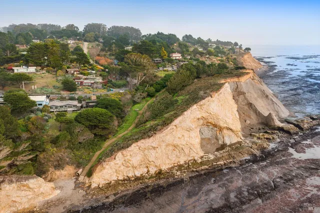 a view of a wooden house with a yard