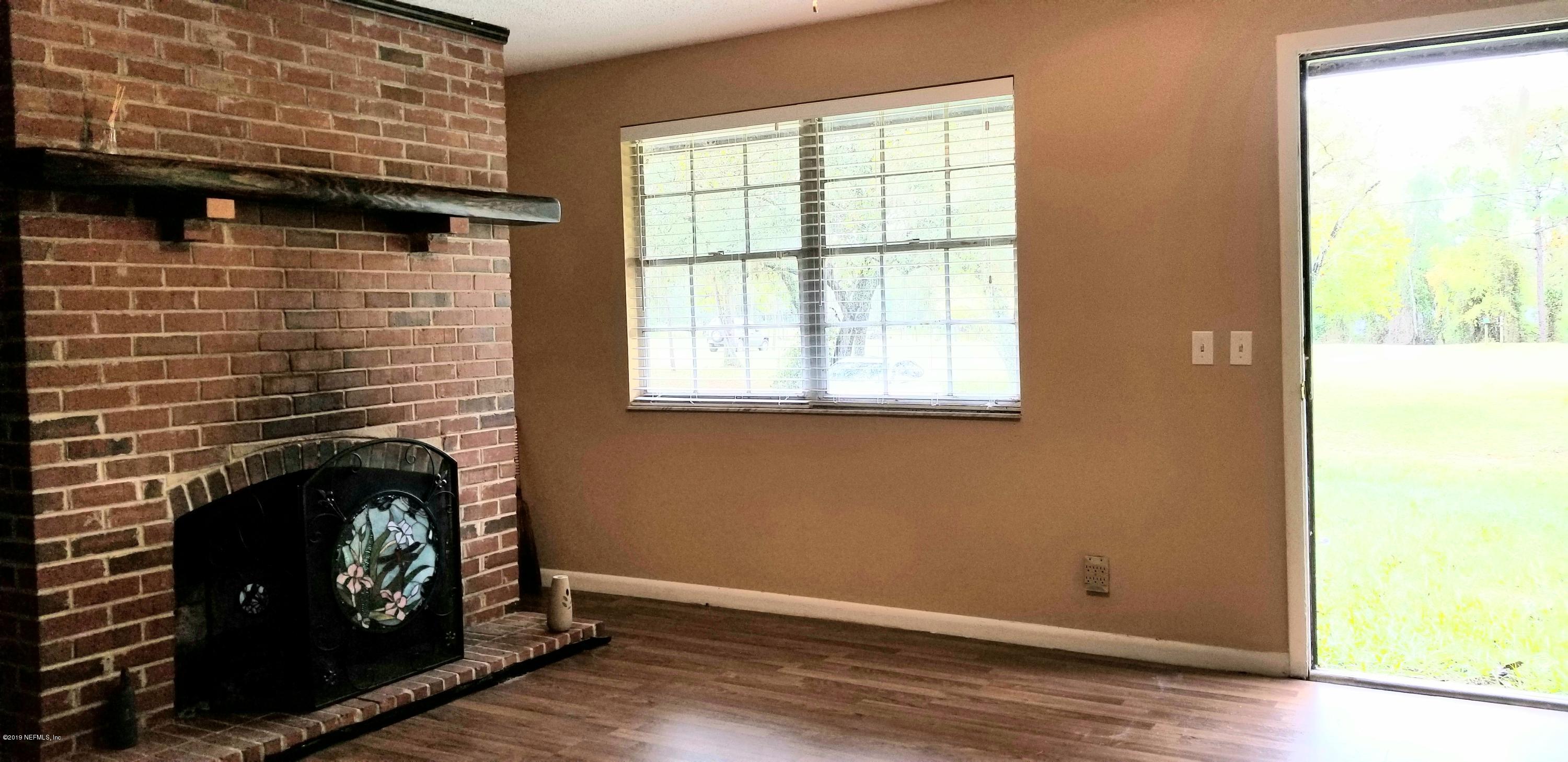 7161 Gas Line Road Keystone Heights, FL 32656 - Photo 3 of 10 a view of an empty room with wooden floor and a window