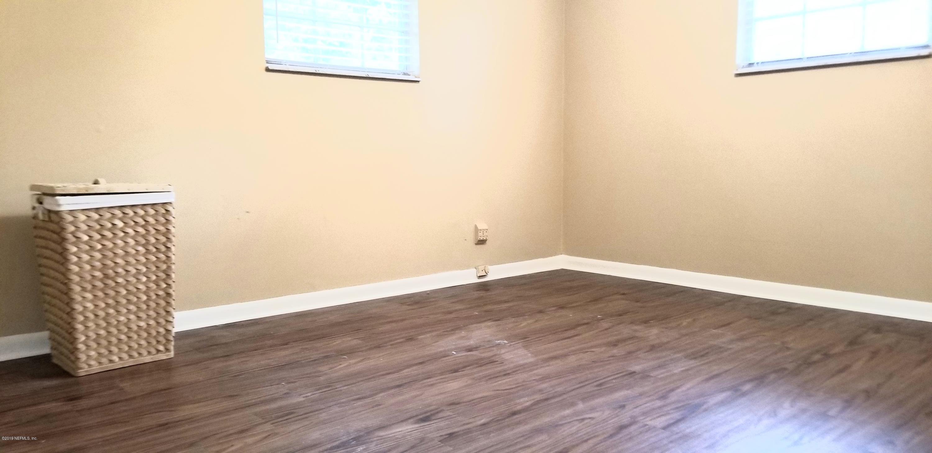 7161 Gas Line Road Keystone Heights, FL 32656 - Photo 4 of 10 an empty room with wooden floor