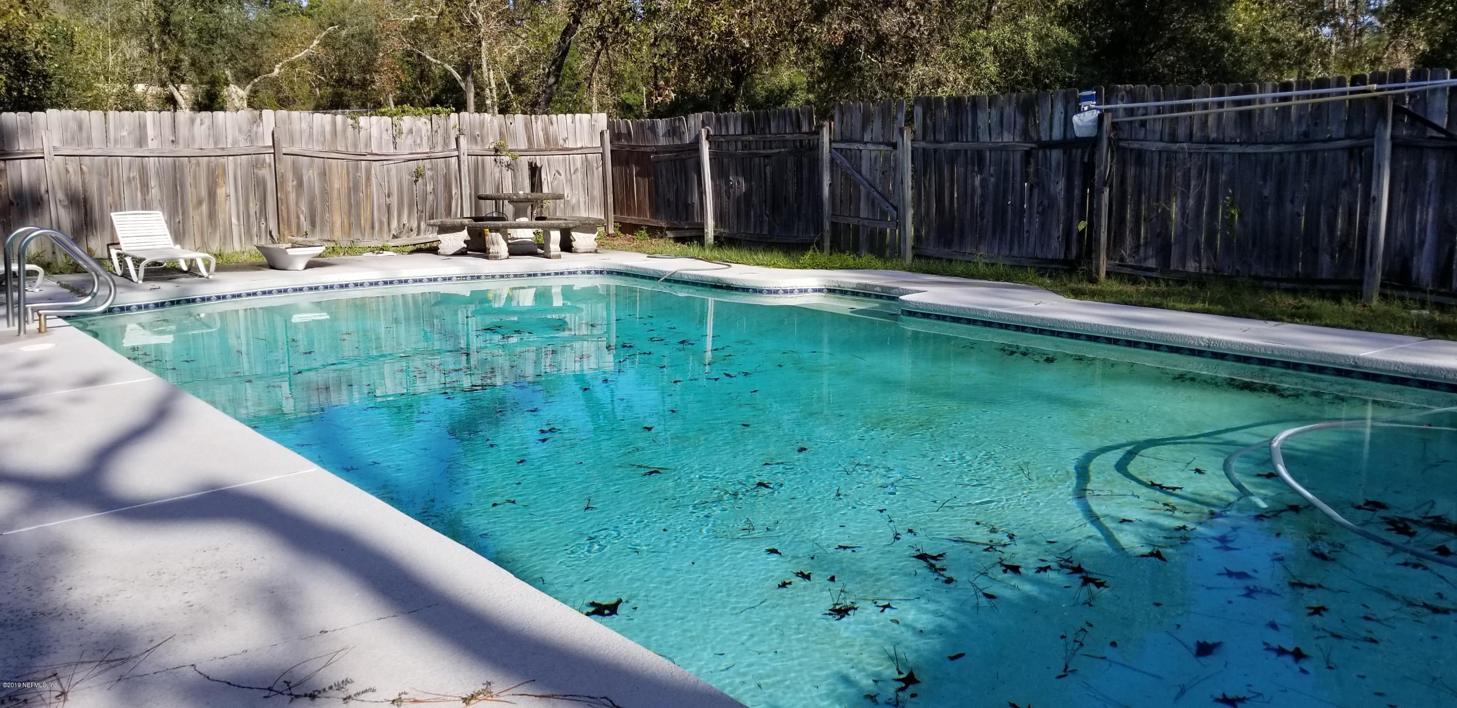 7161 Gas Line Road Keystone Heights, FL 32656 - Photo 8 of 10 a view of a backyard with a small pool and sitting area