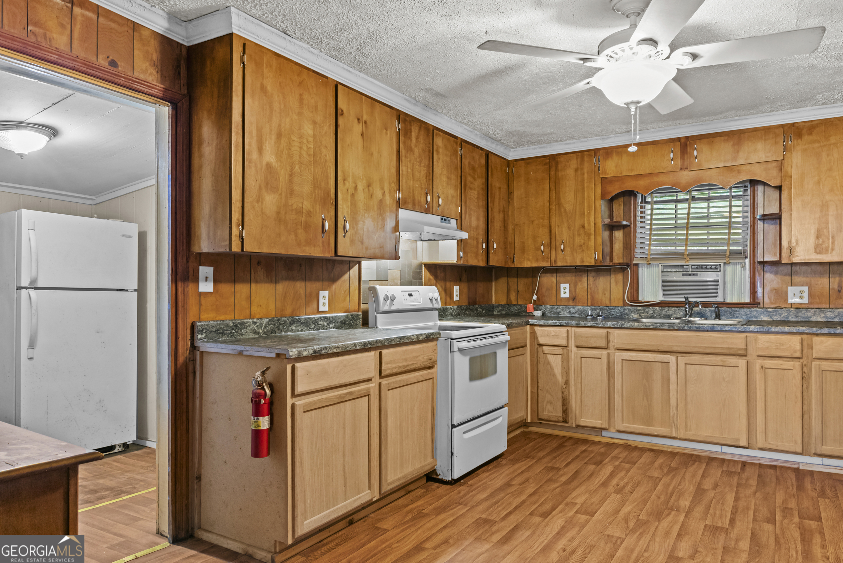 546 South 4th Street Madison, GA 30650 - Photo 11 of 22 a kitchen with stainless steel appliances granite countertop a stove a sink and a refrigerator