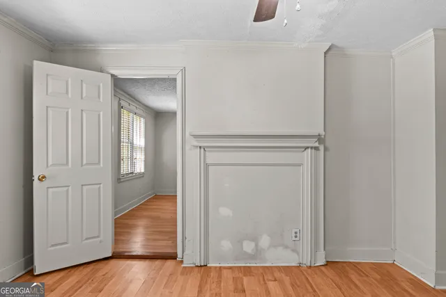 a view of empty room with wooden floor