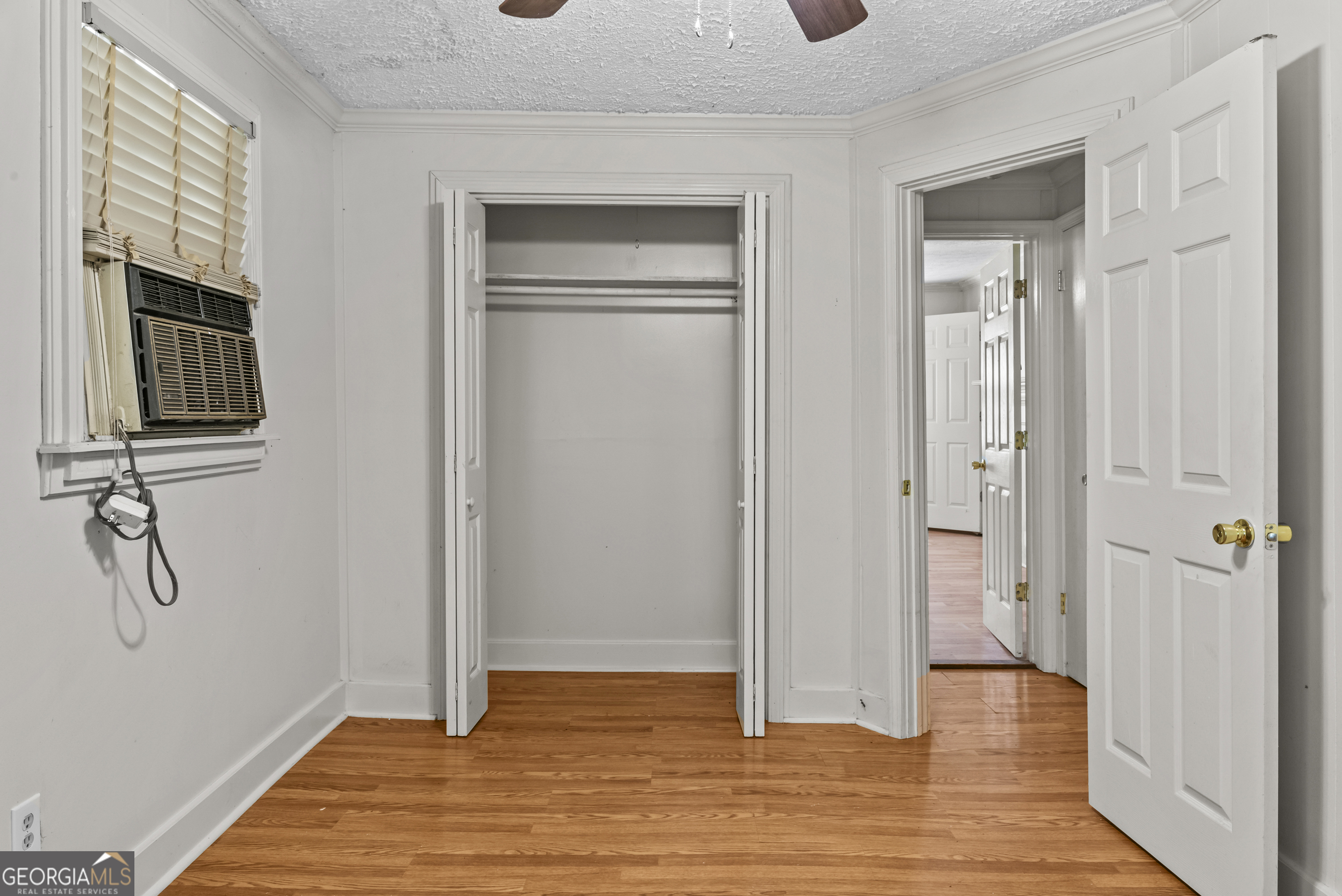 546 South 4th Street Madison, GA 30650 - Photo 19 of 22 a view of an empty room with wooden floor and a bathroom