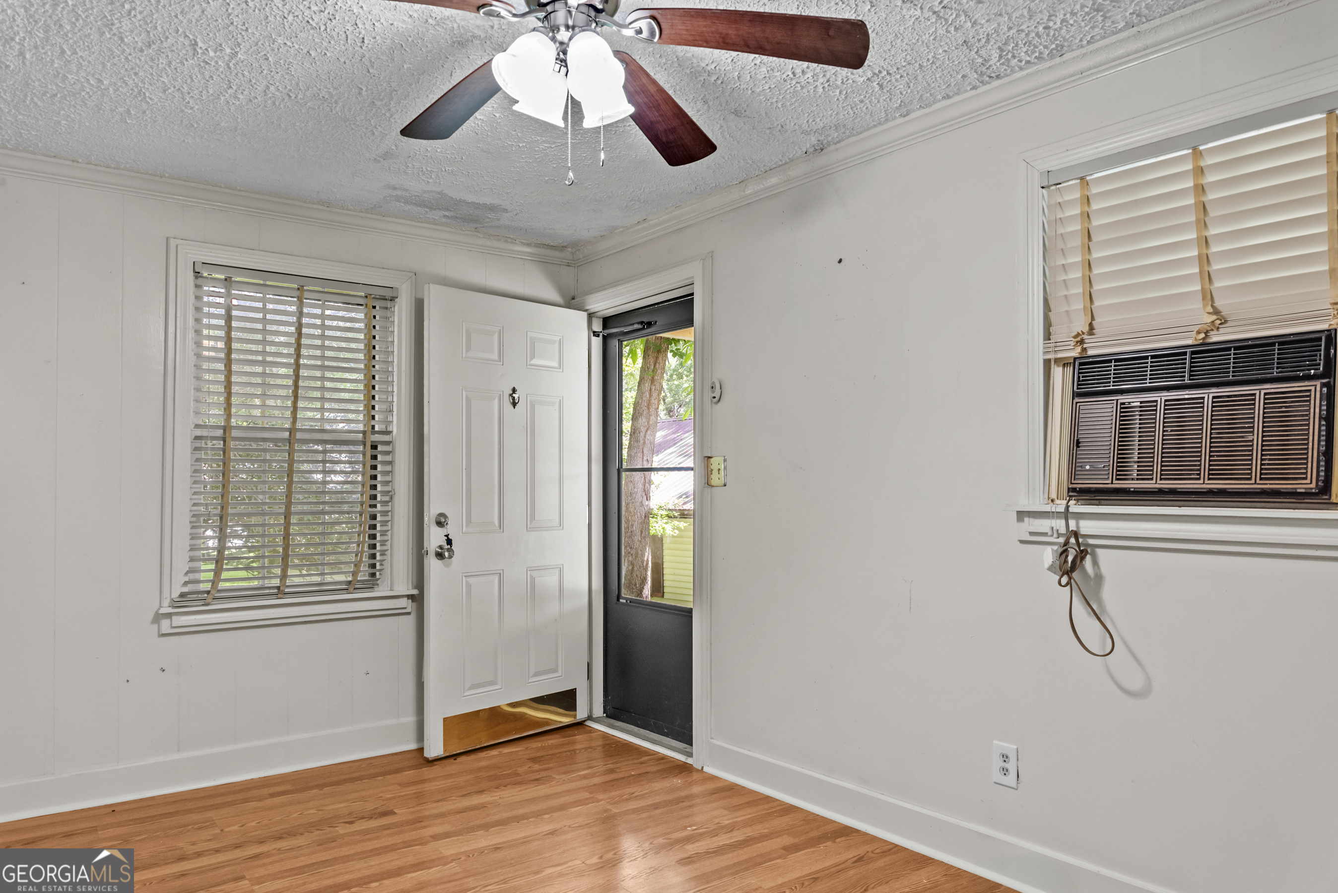 546 South 4th Street Madison, GA 30650 - Photo 20 of 22 a view of an empty room with wooden floor and a window