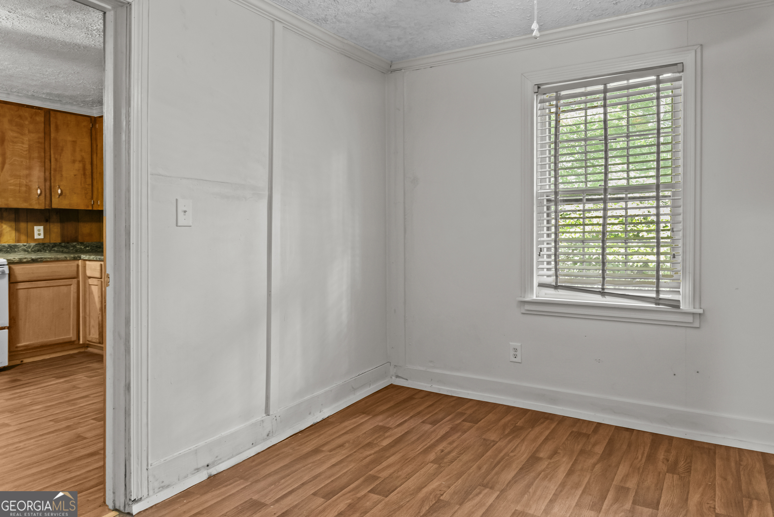 546 South 4th Street Madison, GA 30650 - Photo 22 of 22 a view of an empty room with wooden floor and a window