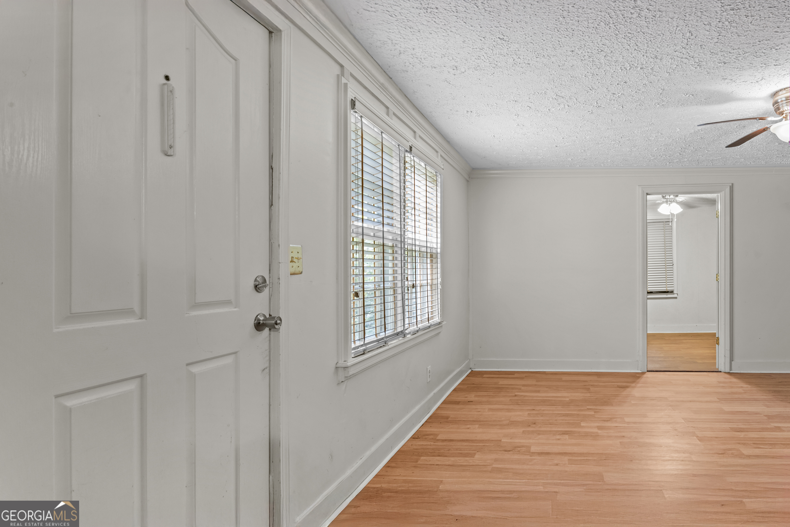 546 South 4th Street Madison, GA 30650 - Photo 7 of 22 a view of an empty room with wooden floor and a window