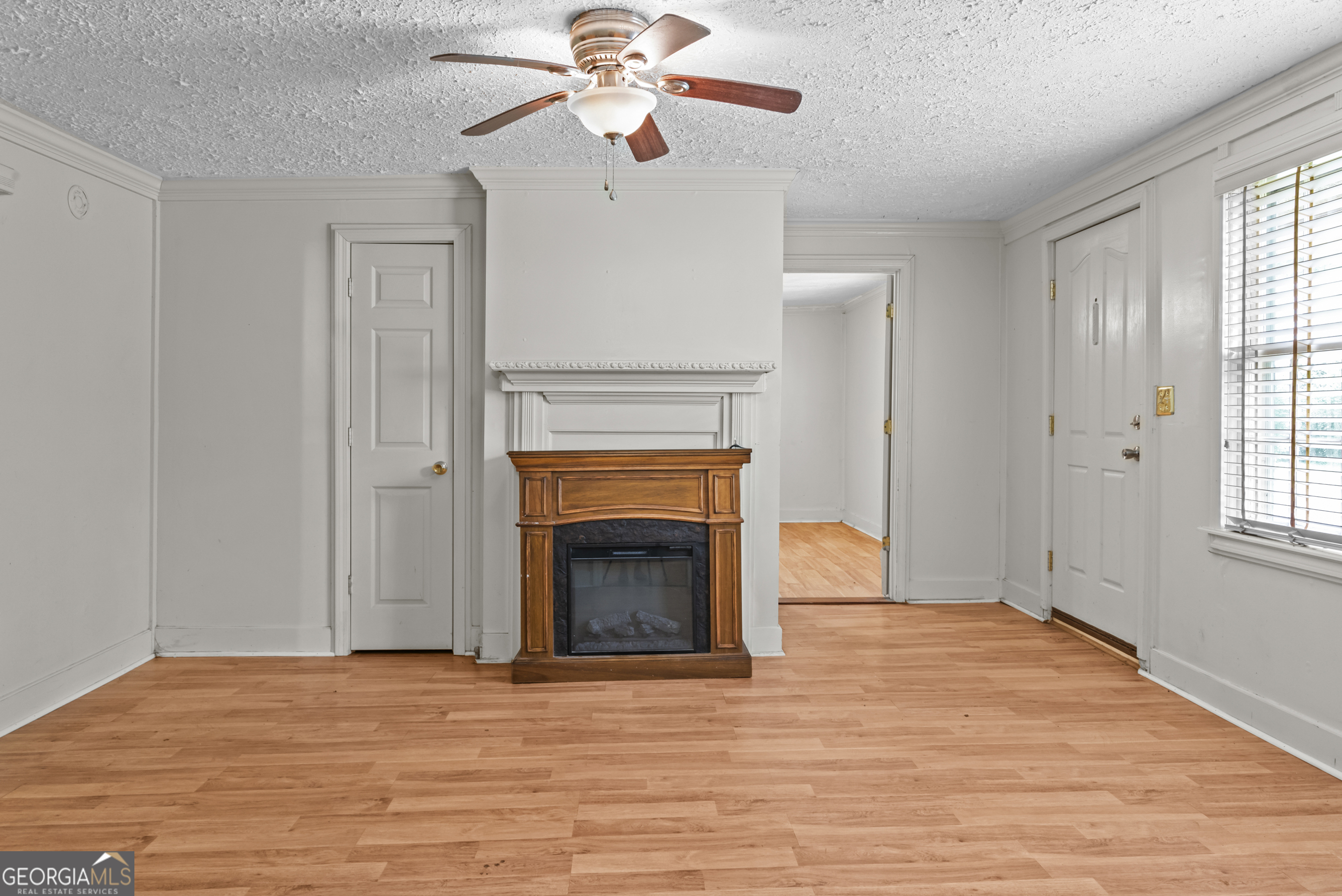 546 South 4th Street Madison, GA 30650 - Photo 8 of 22 wooden floor fireplace and window in an empty room