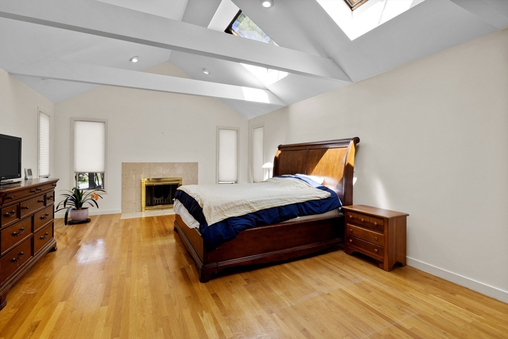 70 Cutters Ridge Road Carlisle, MA 01741 - Photo 17 of 36 a bedroom with a bed and a fireplace