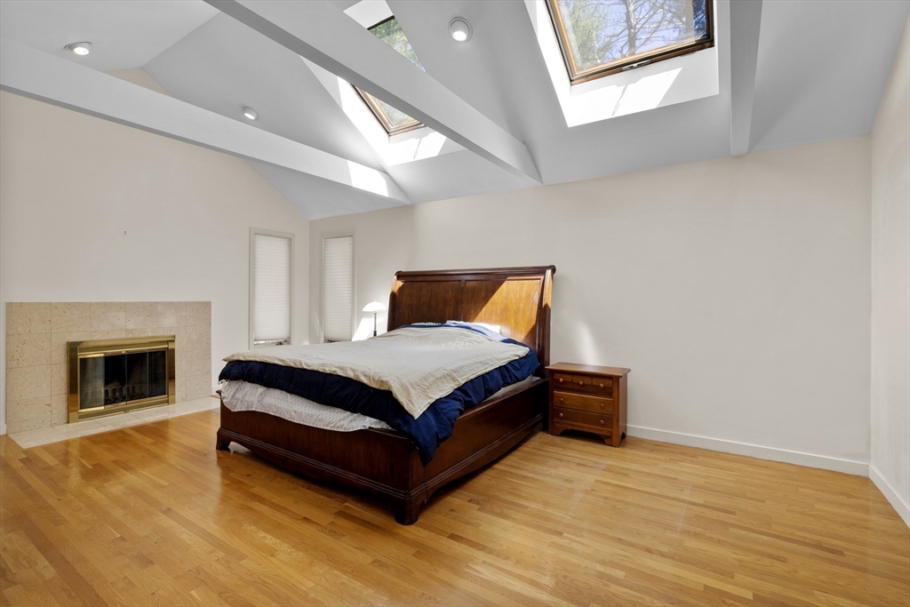 70 Cutters Ridge Road Carlisle, MA 01741 - Photo 18 of 36 a bedroom with a bed and a fireplace