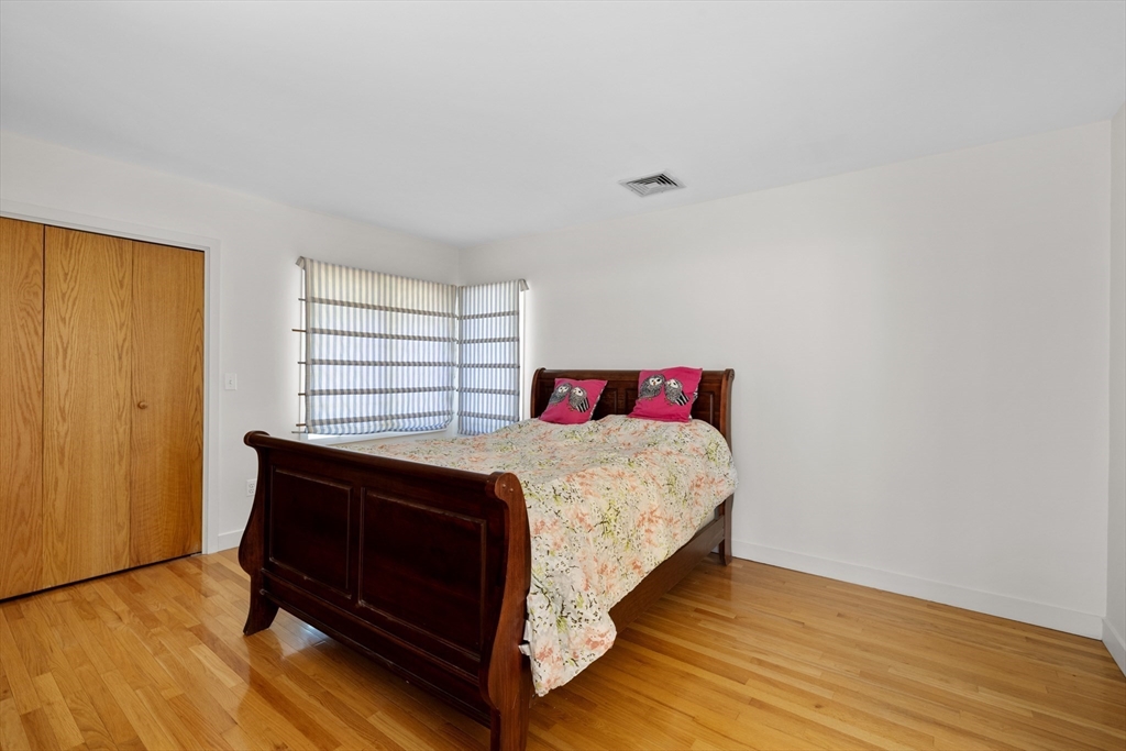 70 Cutters Ridge Road Carlisle, MA 01741 - Photo 21 of 36 a bedroom with a bed and wooden floor