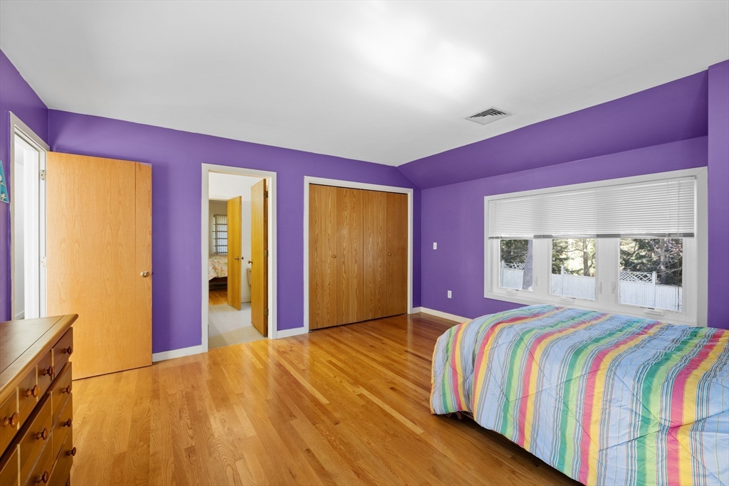 70 Cutters Ridge Road Carlisle, MA 01741 - Photo 24 of 36 a bedroom with a bed and dresser with mirror