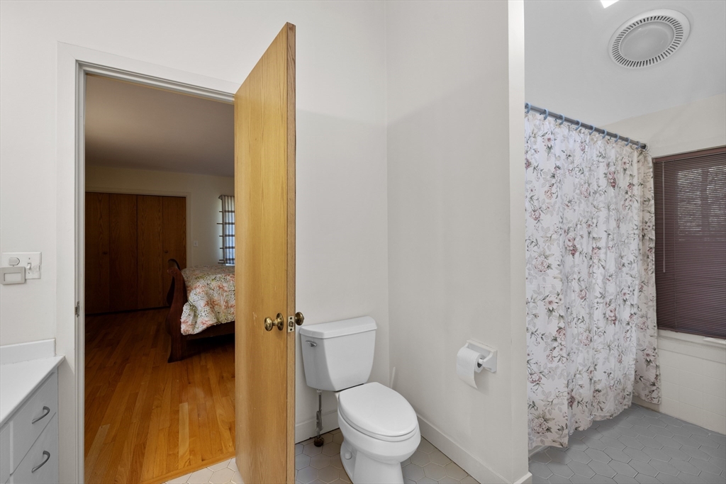 70 Cutters Ridge Road Carlisle, MA 01741 - Photo 27 of 36 a bathroom with a toilet and a shower curtain