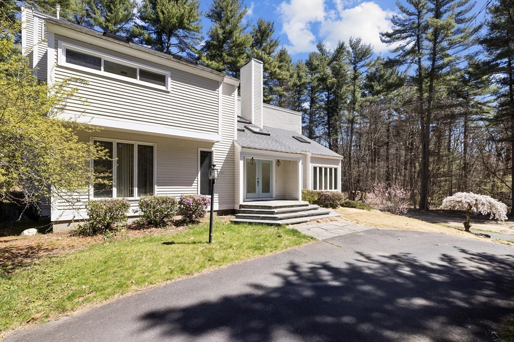 70 Cutters Ridge Road Carlisle, MA 01741 - Photo 36 of 36 a front view of a house with garden and porch