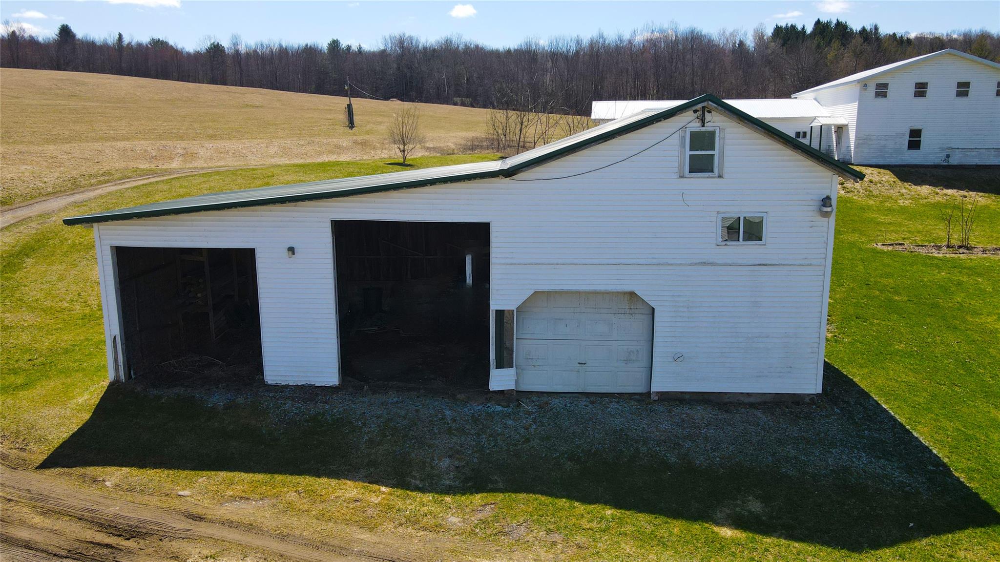 892 Bowbell Road Greene, NY 13778 - Photo 24 of 35 View of home's exterior with a lawn, an outbuilding, a view of trees, and a detached garage
