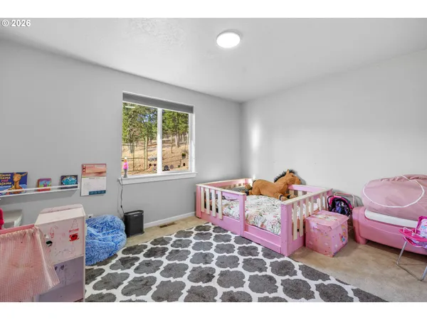 a bedroom with furniture and a window