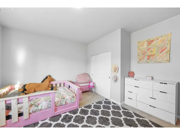 a bedroom with a bed and a dresser in it
