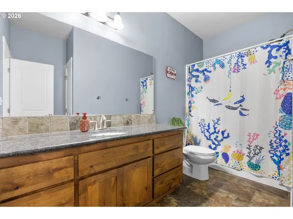 a bathroom with a sink mirror vanity and toilet