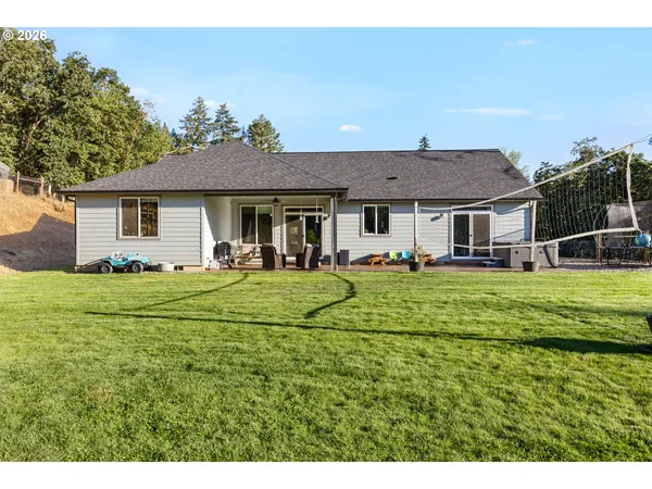 a front view of a house with a yard table and chairs