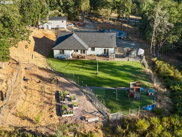 an aerial view of a house with a yard