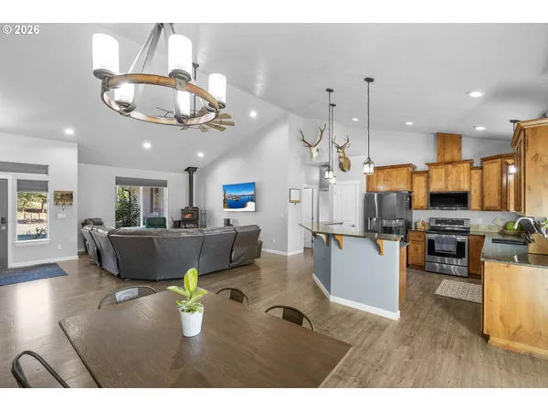 a living room with lots of furniture and kitchen view