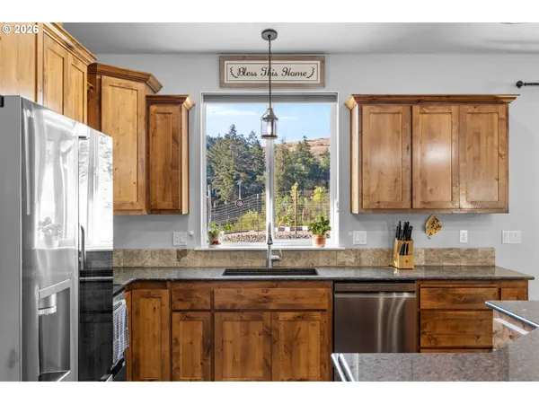 a kitchen with a sink window and cabinets
