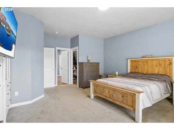 a bedroom with a bed and dresser