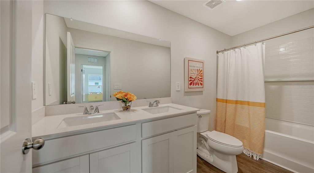 13113 Bayberry Way Parrish, FL 34219 - Photo 13 of 20 a bathroom with a sink a toilet a shower and a mirror