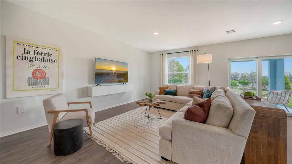 13113 Bayberry Way Parrish, FL 34219 - Photo 4 of 20 a living room with furniture and a flat screen tv