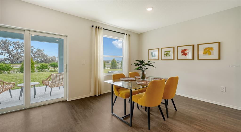 13113 Bayberry Way Parrish, FL 34219 - Photo 5 of 20 a dining room with furniture and wooden floor