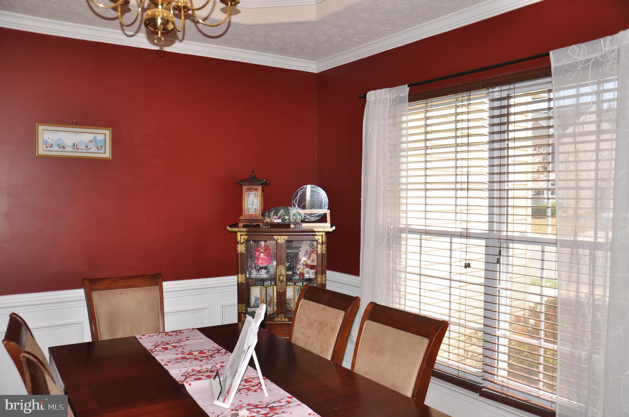 10621 Gallant Fox Way Ruther Glen, VA 22546 - Photo 16 of 65 a view of a dining room with furniture and wooden floor