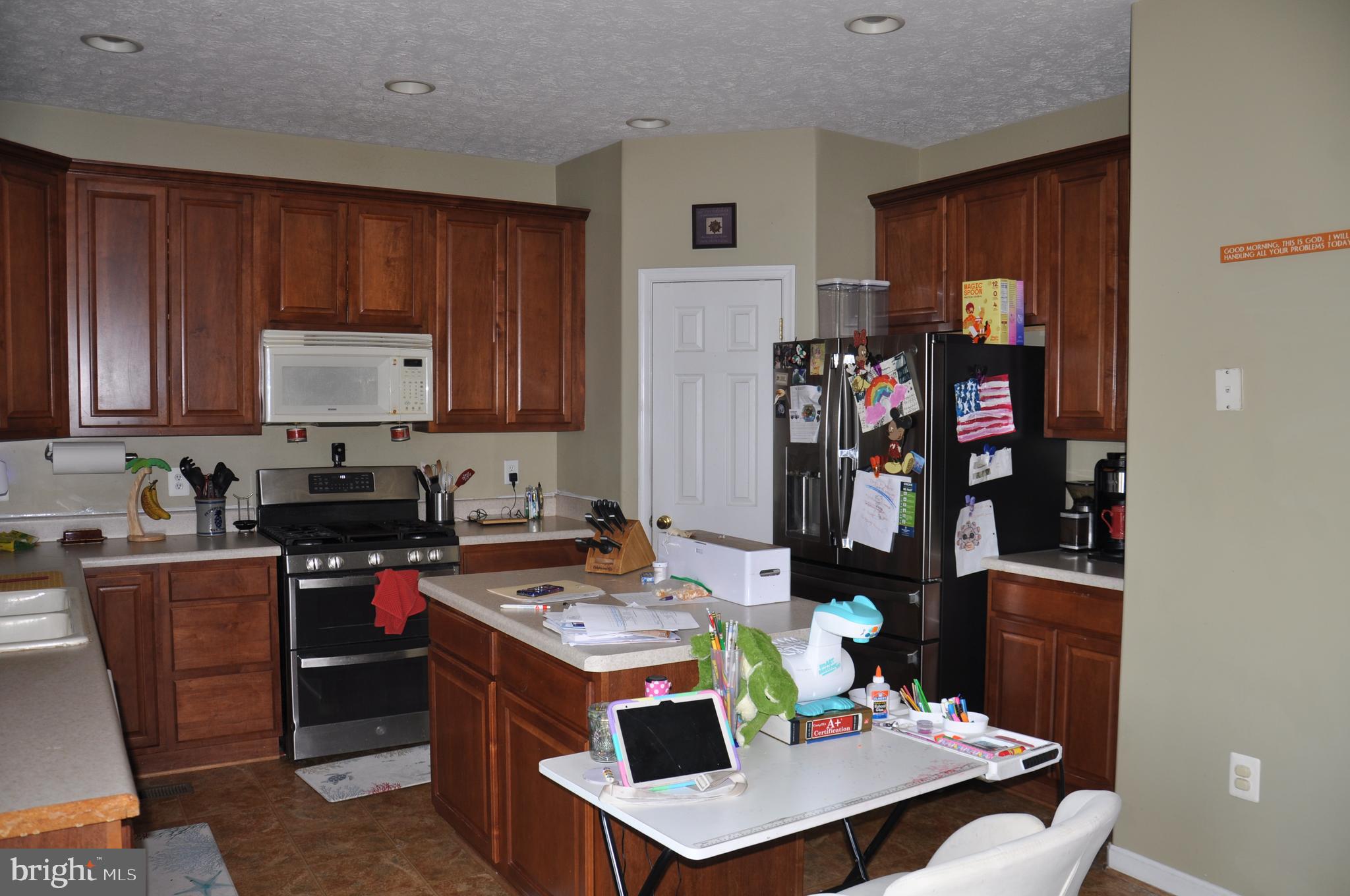 10621 Gallant Fox Way Ruther Glen, VA 22546 - Photo 22 of 65 a kitchen with stainless steel appliances granite countertop a stove refrigerator and cabinets