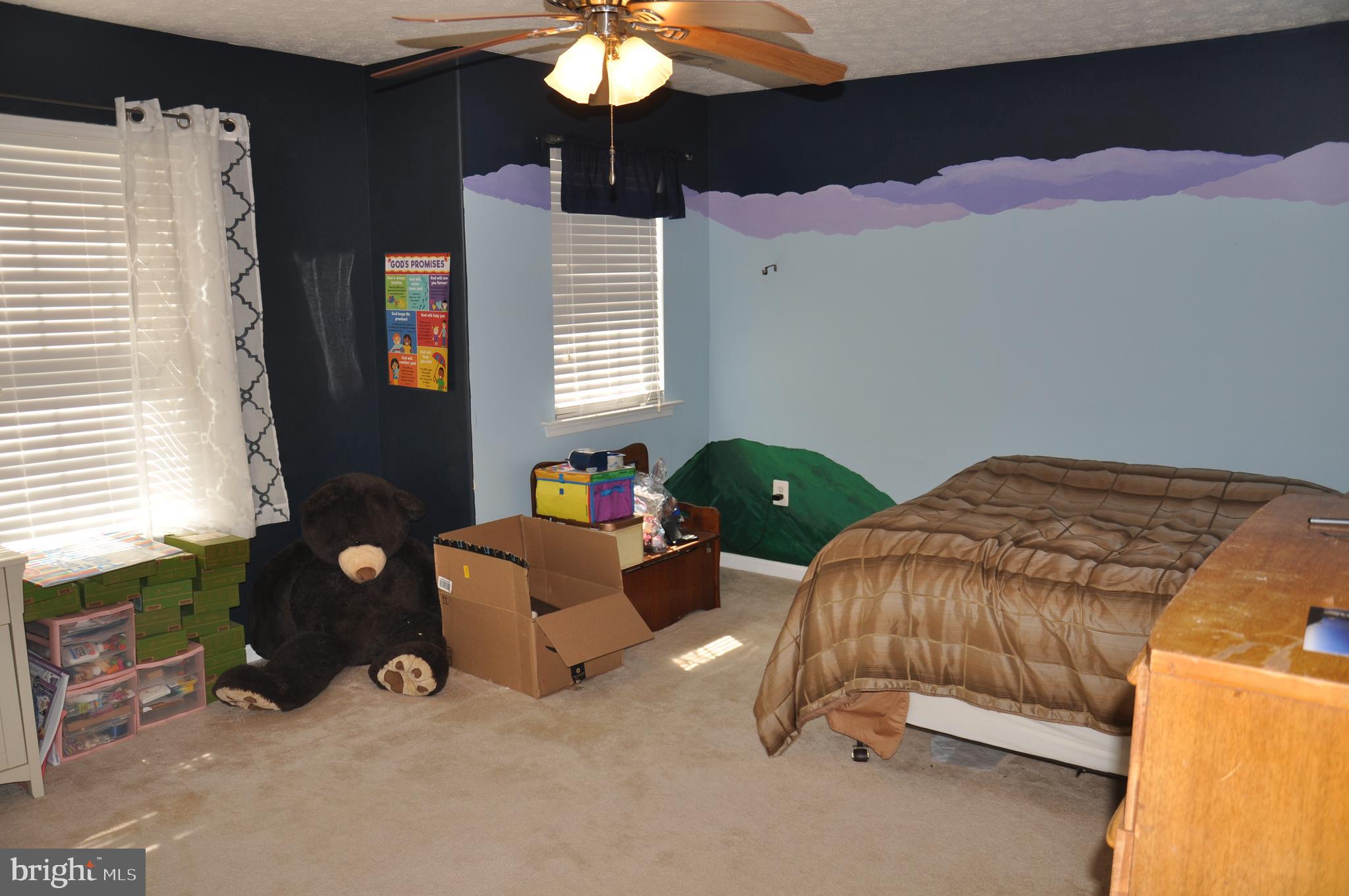 10621 Gallant Fox Way Ruther Glen, VA 22546 - Photo 39 of 65 a bedroom with a bed and a chandelier