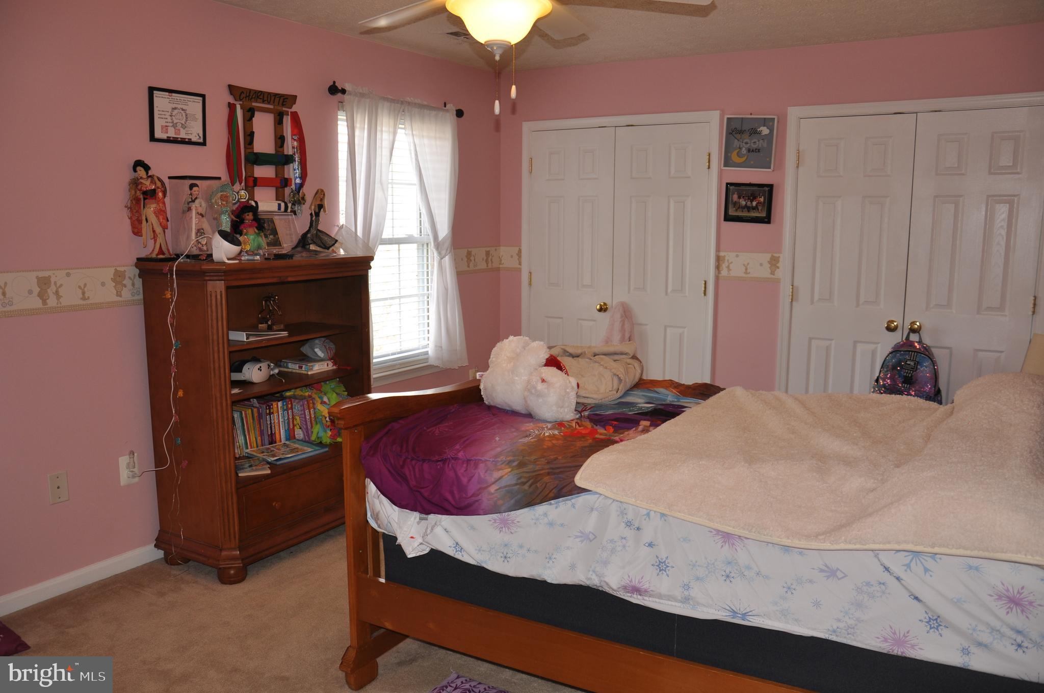10621 Gallant Fox Way Ruther Glen, VA 22546 - Photo 49 of 65 a bedroom with a bed and a chandelier