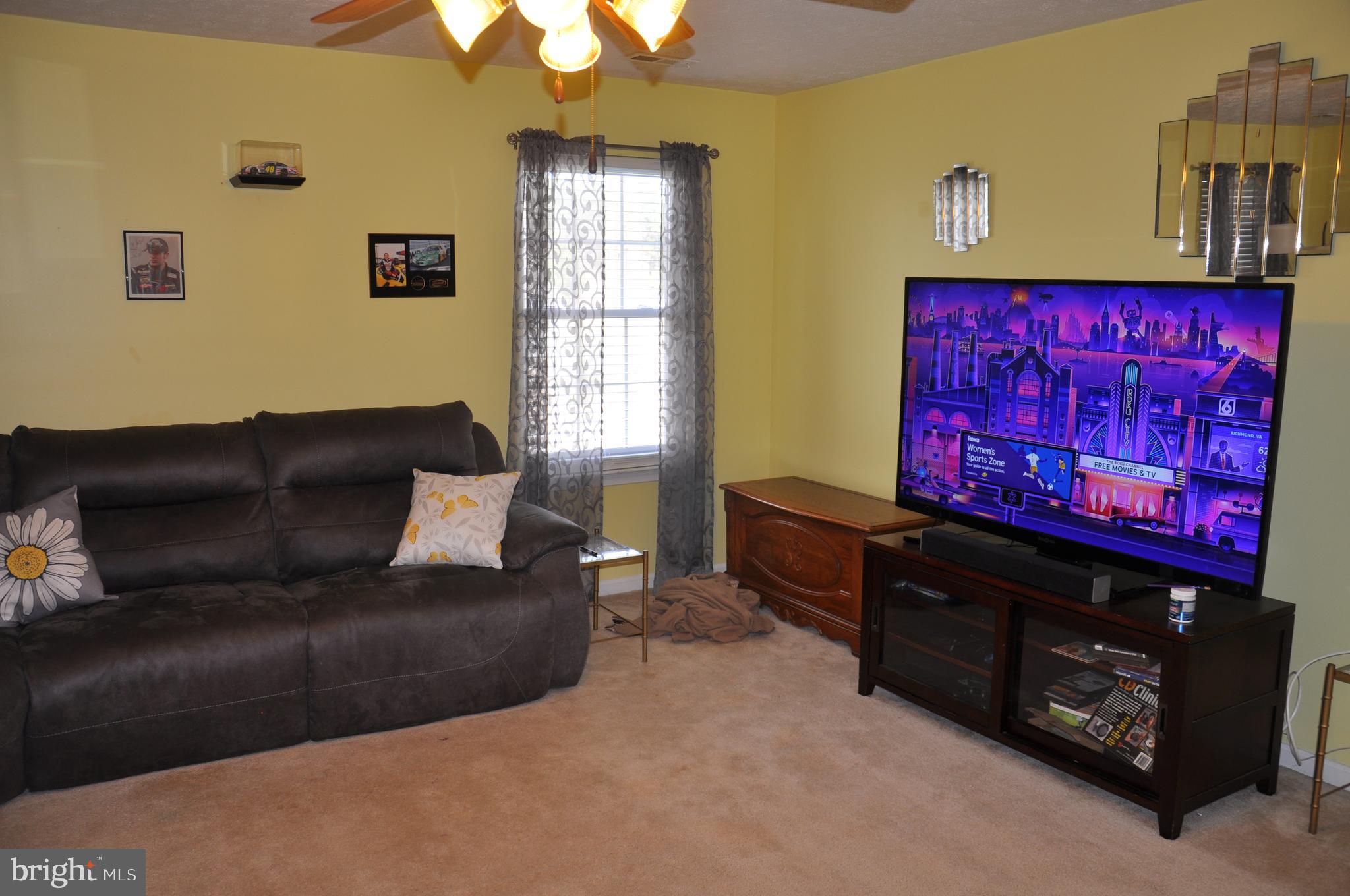10621 Gallant Fox Way Ruther Glen, VA 22546 - Photo 52 of 65 a living room with furniture and a window