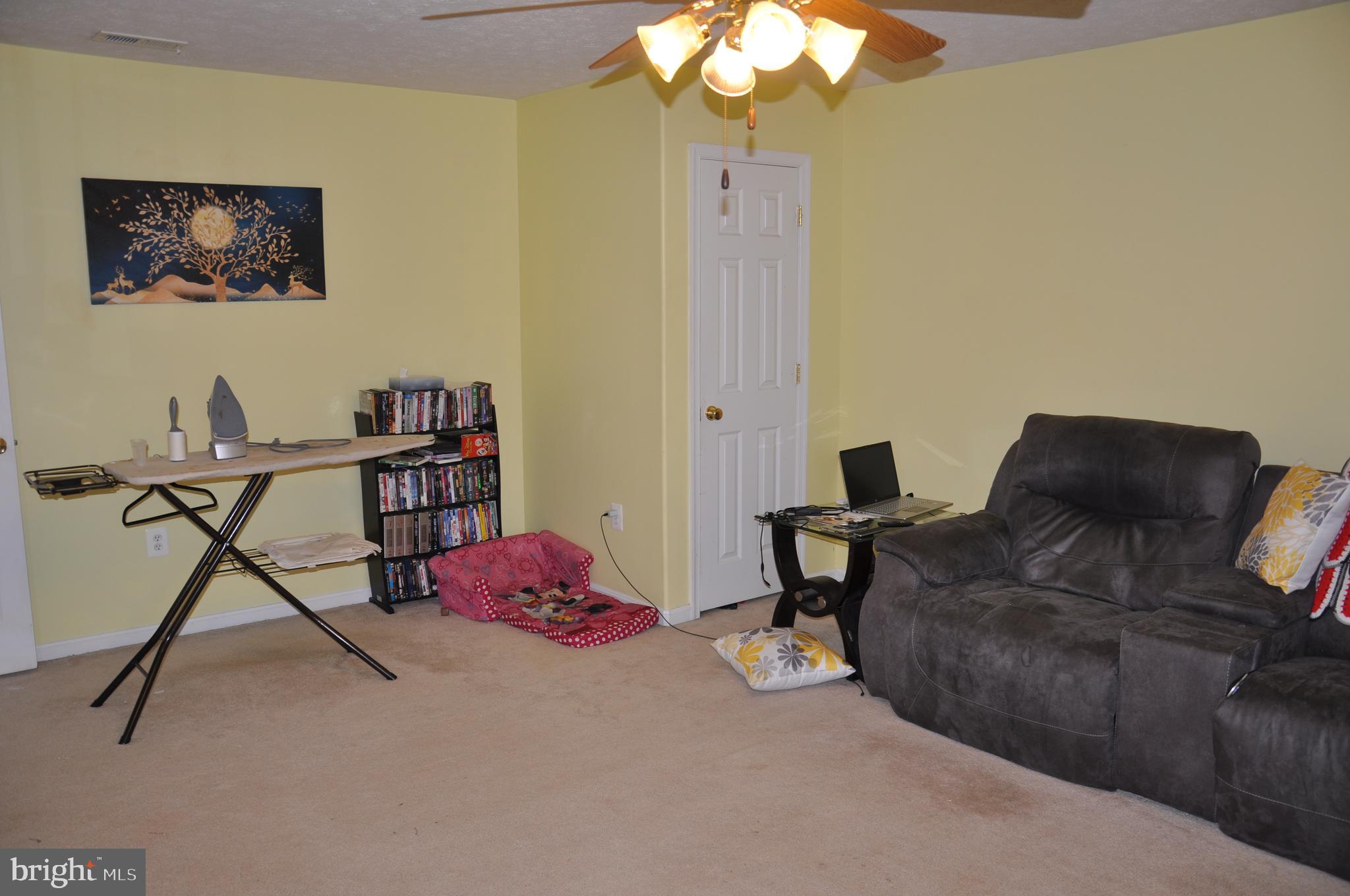 10621 Gallant Fox Way Ruther Glen, VA 22546 - Photo 53 of 65 a living room with furniture and a window