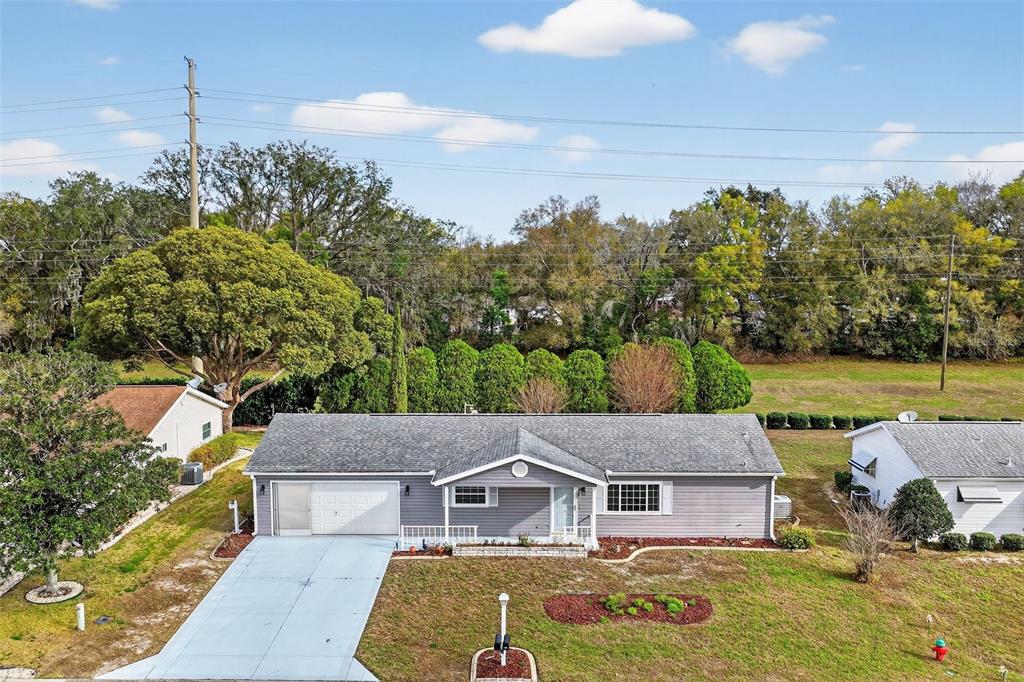 an aerial view of a house with swimming pool and big yard
