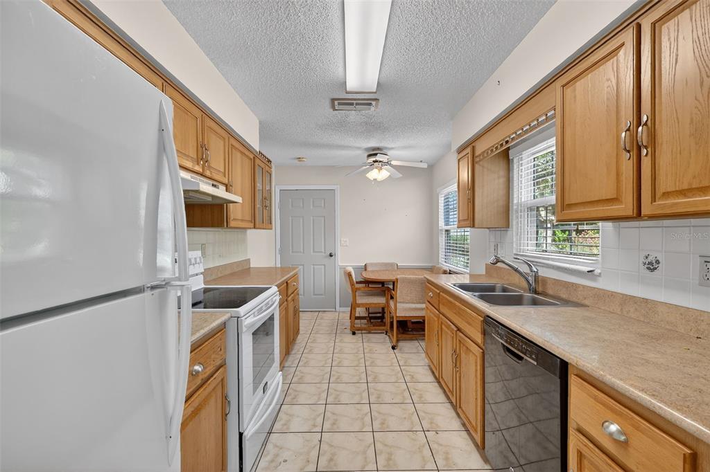 9398 Southeast 174th Loop Summerfield, FL 34491 - Photo 11 of 29 a kitchen with stainless steel appliances a sink stove and cabinets
