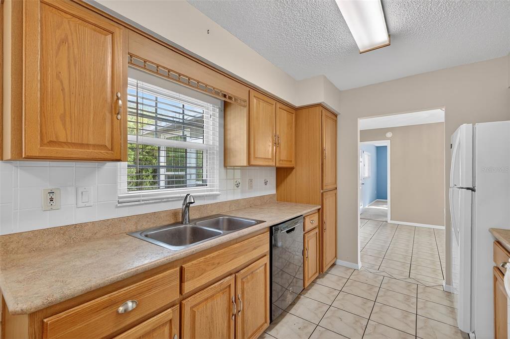 9398 Southeast 174th Loop Summerfield, FL 34491 - Photo 12 of 29 a kitchen that has a sink and cabinets